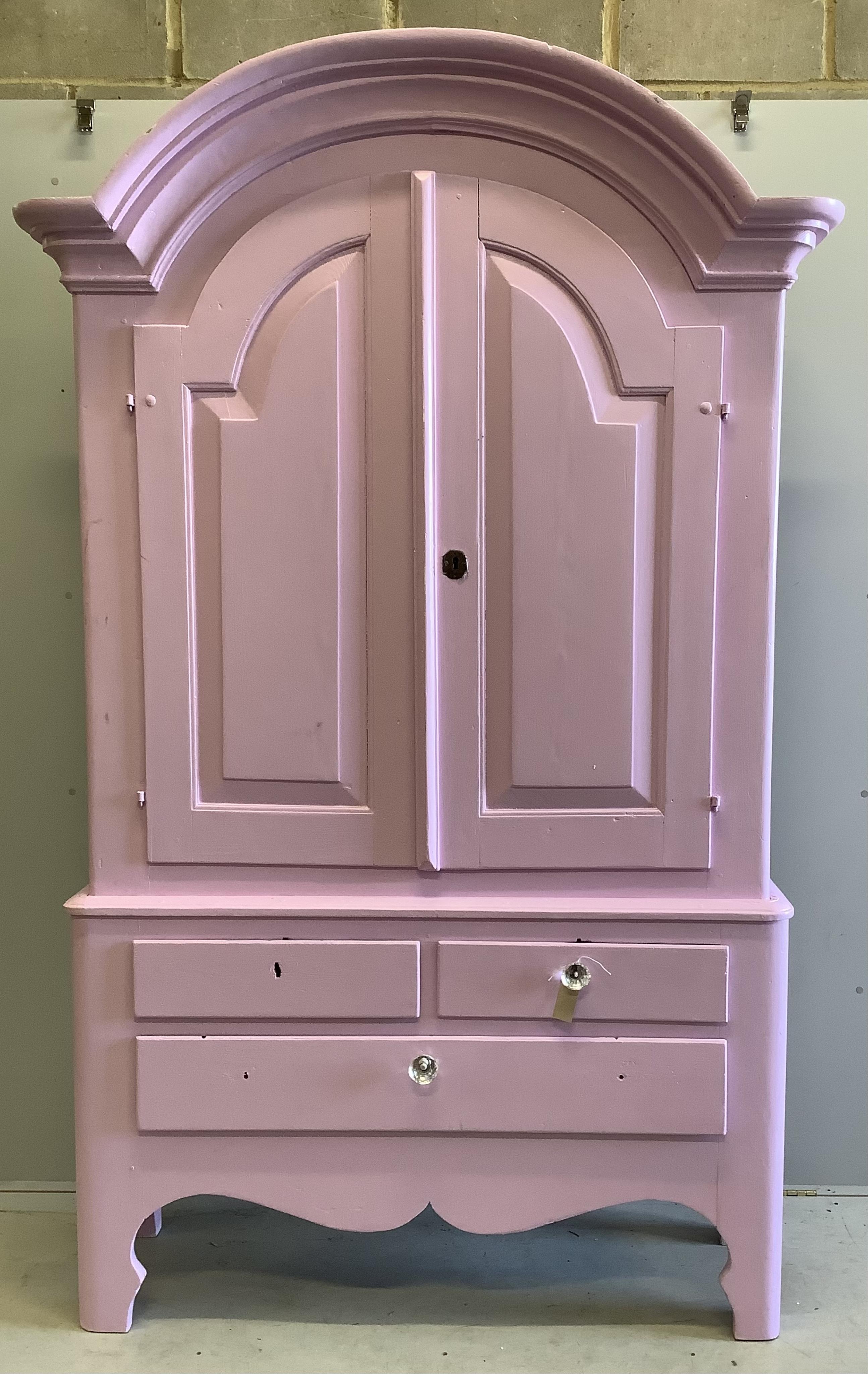 An early 19th century Continental pine armoire, later painted pink, width 136cm, depth 48cm, height 224cm. Condition - fair